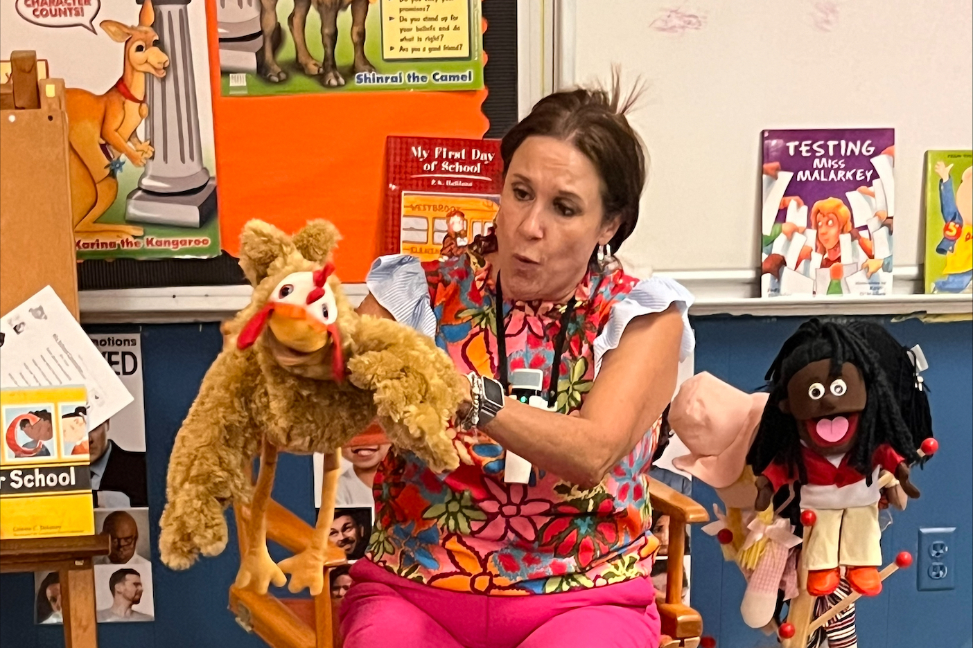 Counselor Zuniga holds rooster puppet